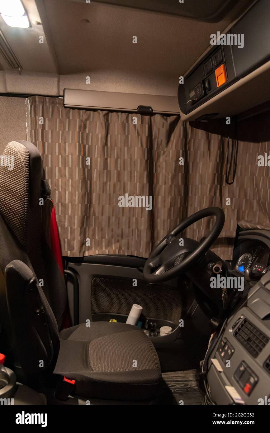 Inside the cab of a truck with the curtains closed, driving position. Stock Photo