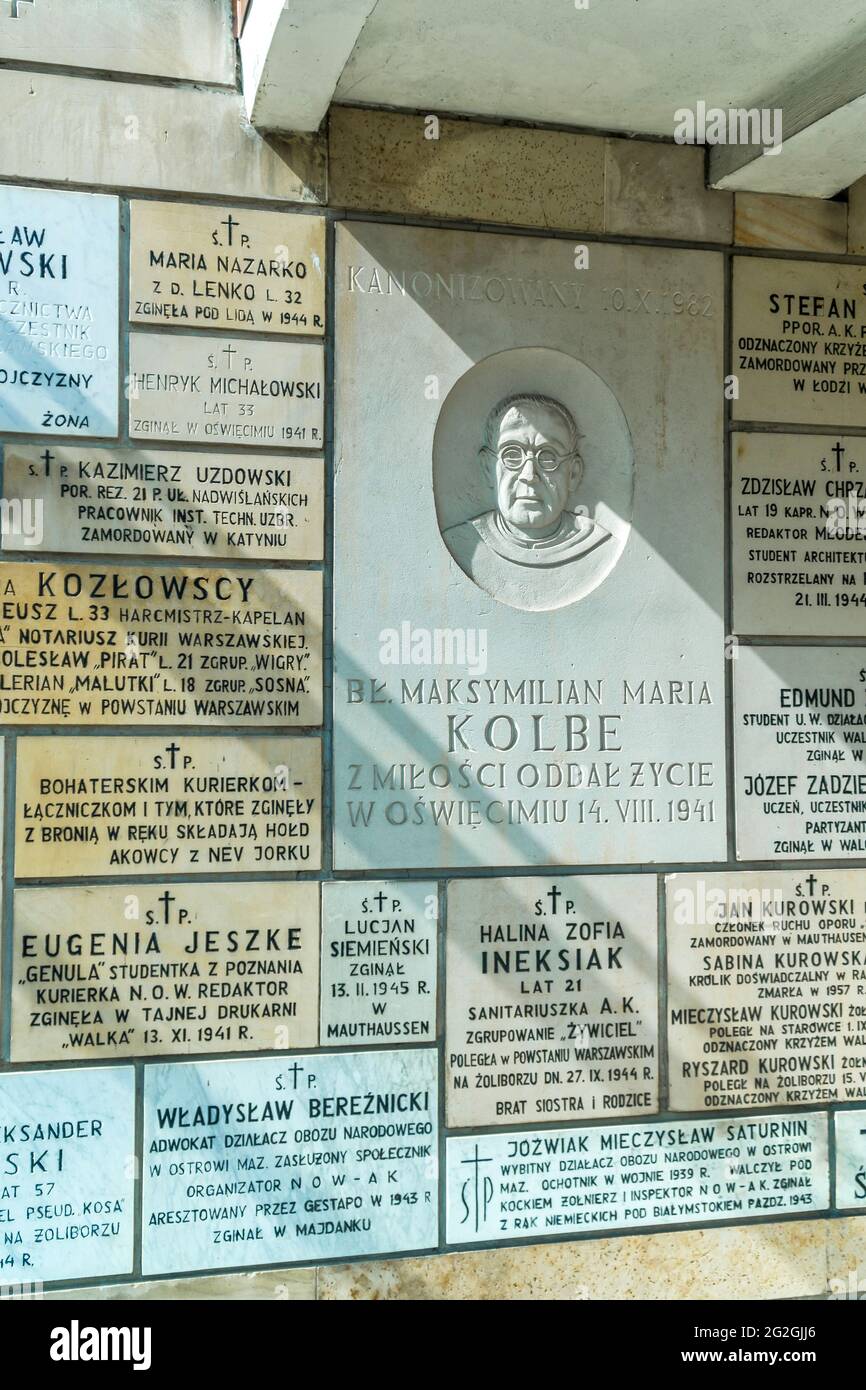 Commemorative plaque dedicated to St Maximilian Maria Kolbe (1894-1941) on the wall of the St Stanislaus Kostka church - Warsaw, Poland. Stock Photo