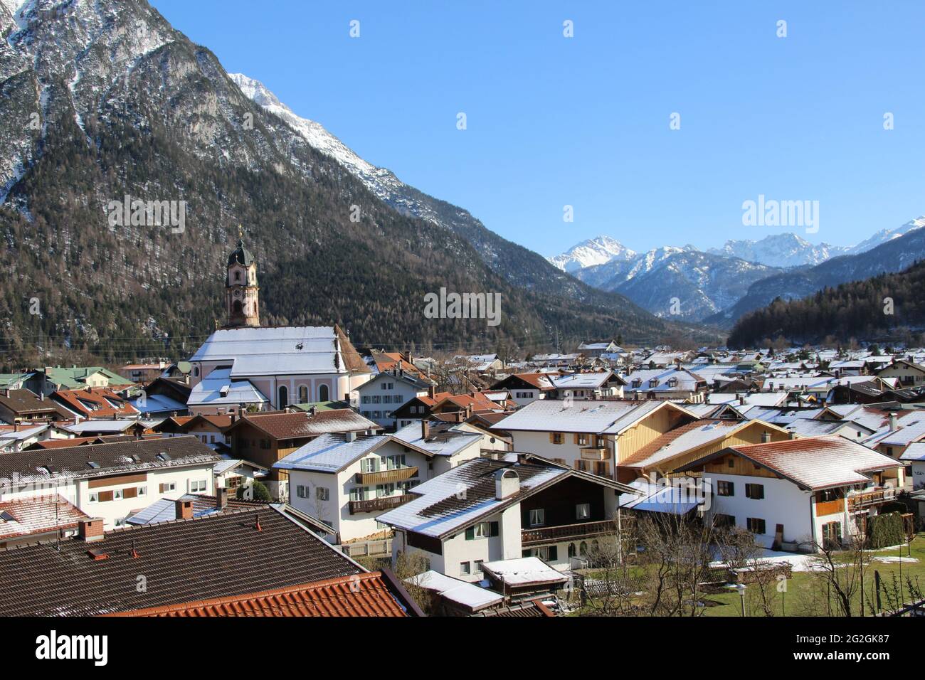Spring walk with a fantastic view of Mittenwald and the parish church St. Peter & Paul, town overview, Europe, Germany, Bavaria, Upper Bavaria, Werdenfels, winter, Karwendel Mountains, church Stock Photo