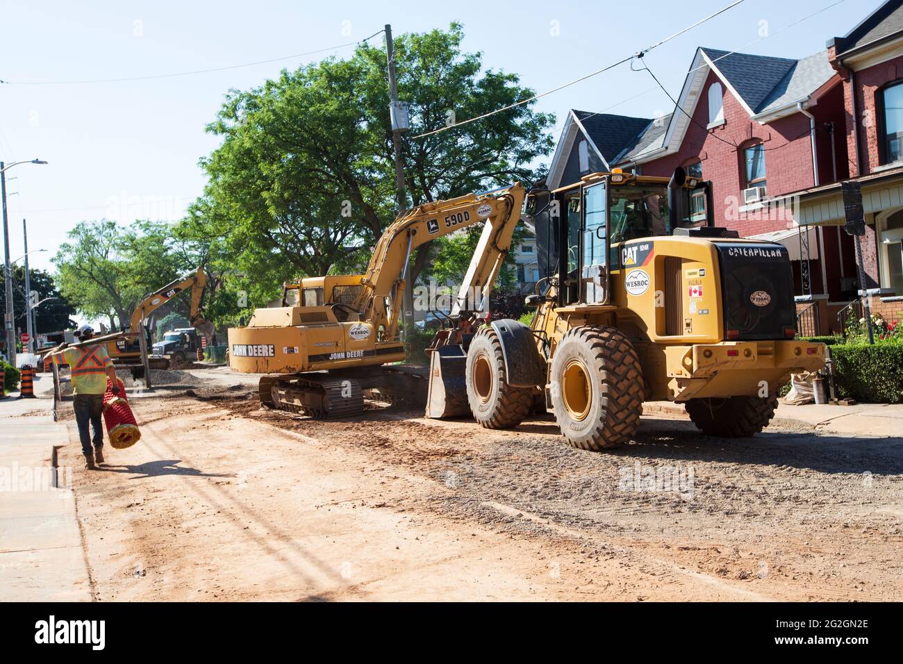 Construction machinery are on site doing road repairs and sewer pipe replacement in downtown Hamilton. Stock Photo