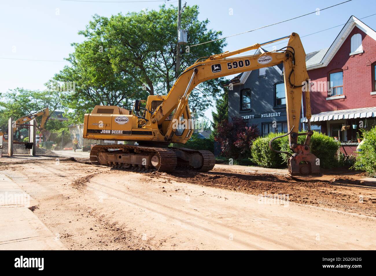 Heavy duty construction machines are working on the road at Mulberry street in Hamilton. Stock Photo