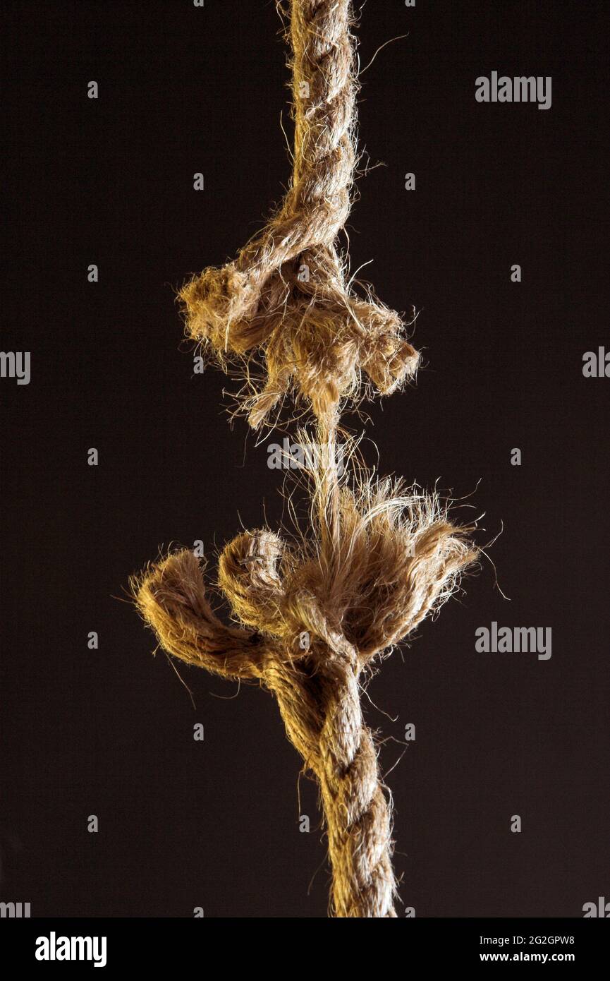 Hanging by a thread breaking rope Stock Photo Alamy