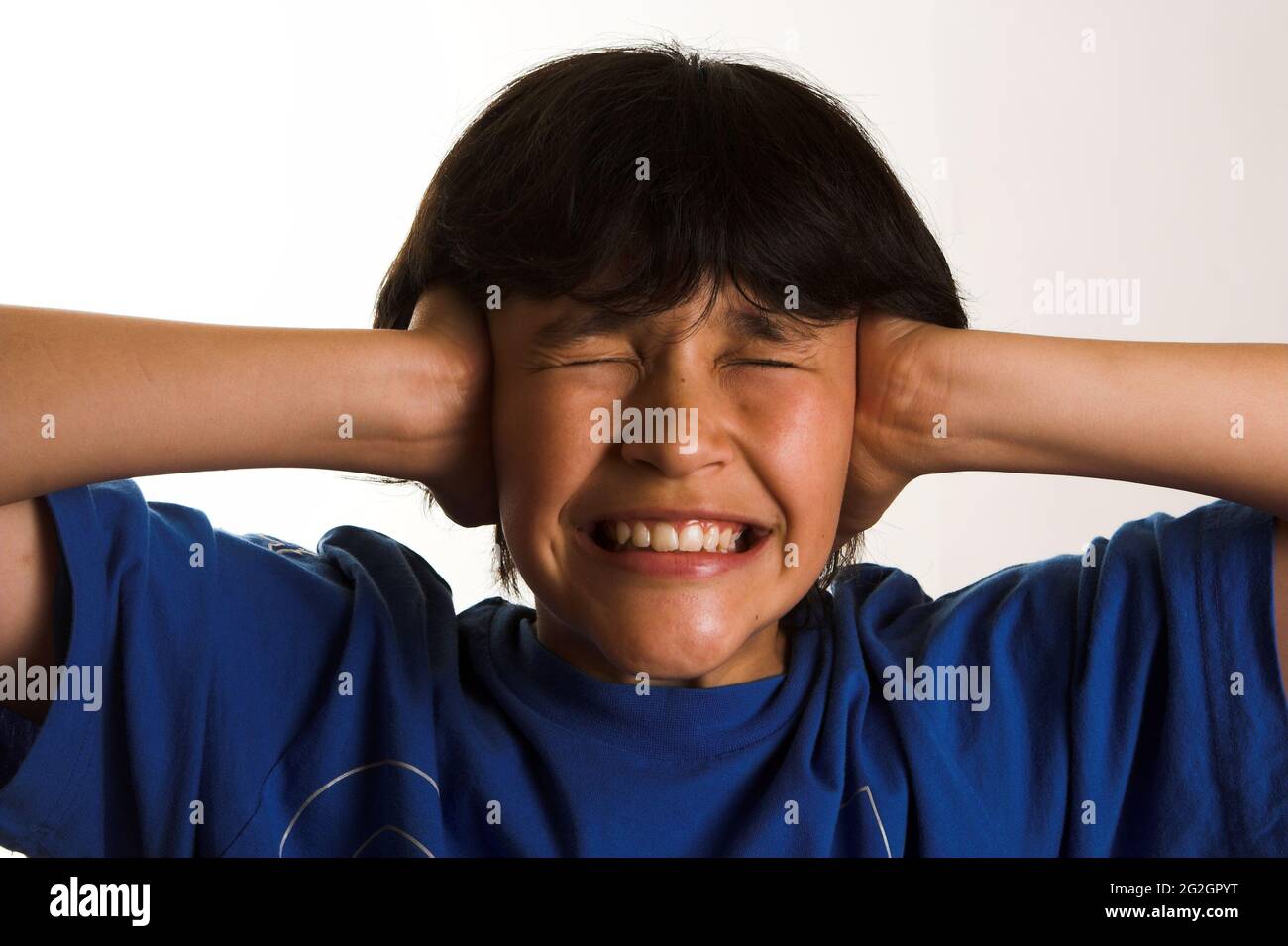 Boy getting crazy due to noise Stock Photo