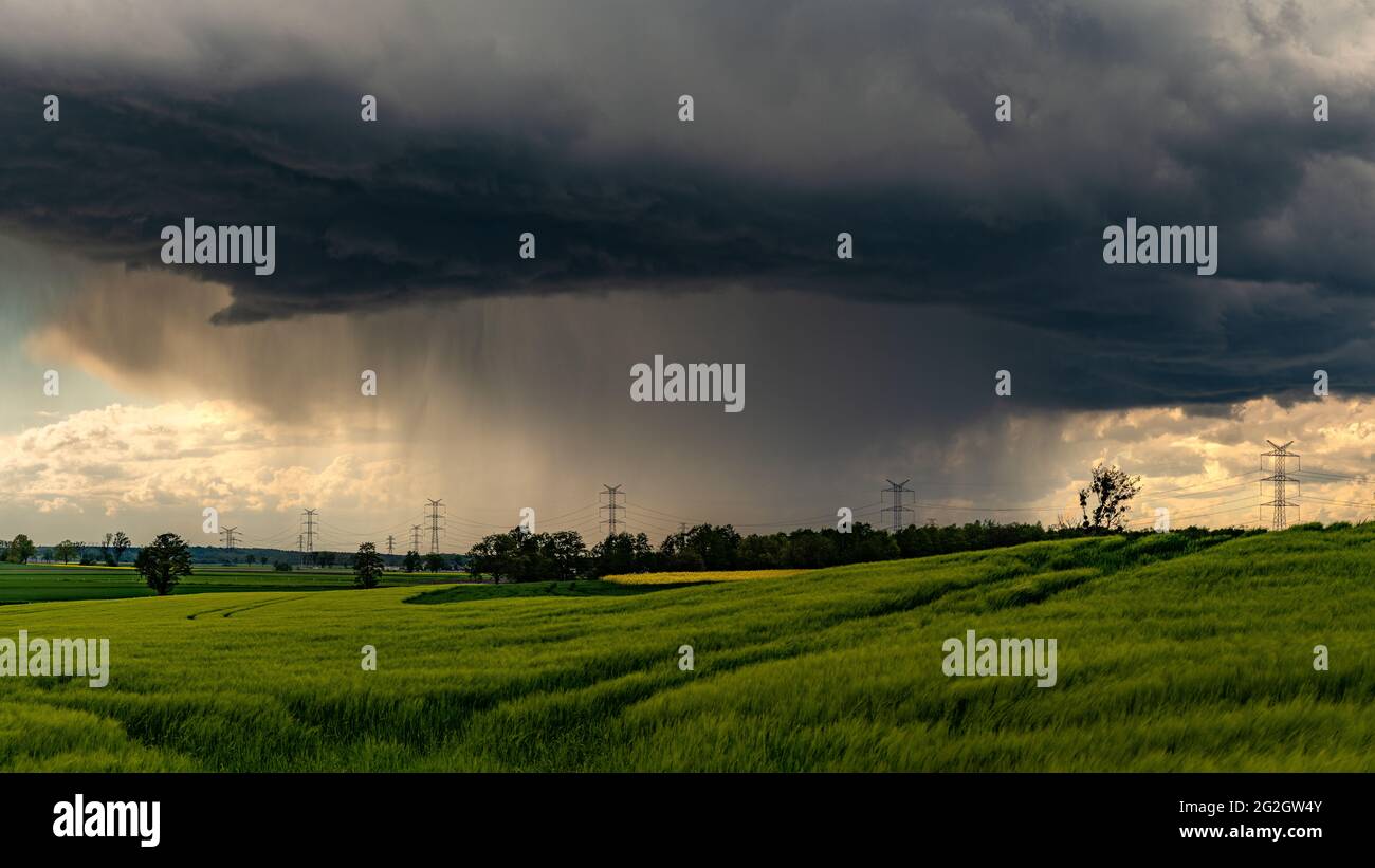 Dark stormy sky over a green meadow Stock Photo - Alamy