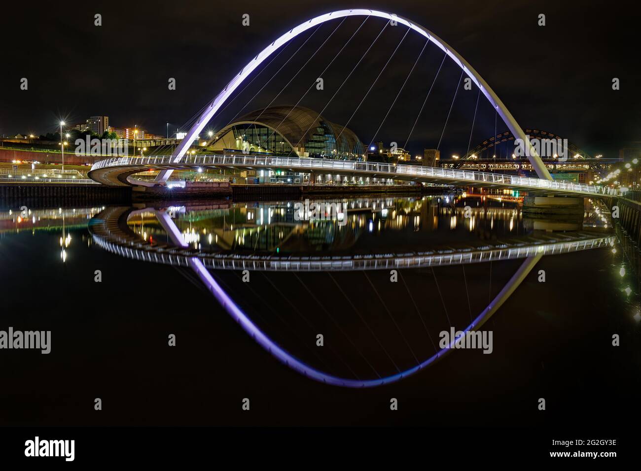 Newcastle's Millennium Bridge Reflecting On The River Tyne at Night. Stock Photo