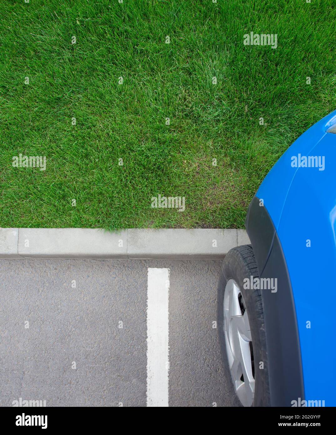 car in the parking lot with green grass background for your text Stock Photo