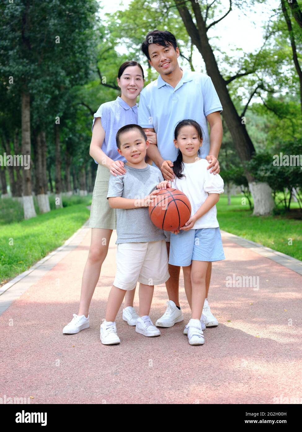 Happy family of four playing in the park high quality photo Stock Photo ...