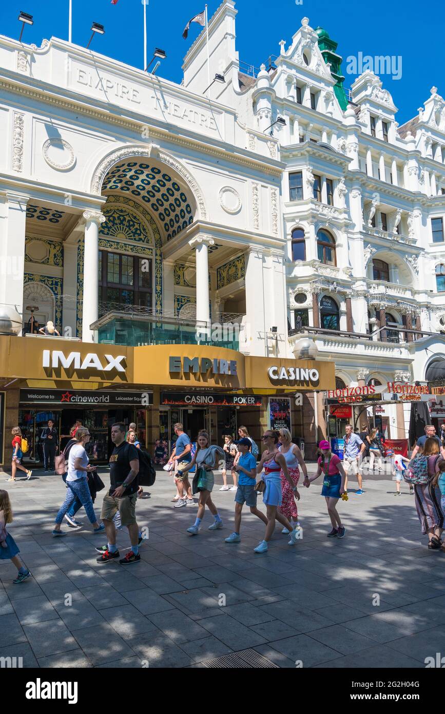 People out and about in Leicester Square pass by the Cineworld Multiplex cinema. London, England, UK Stock Photo