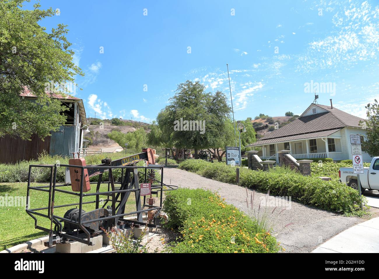 BREA, CALIFORNIA - 9 JUN 2021:  Shallow Well Pumping Lift at the Olinda Oil Museum, with main building, trail head and Jack Line Pump Unit building. Stock Photo