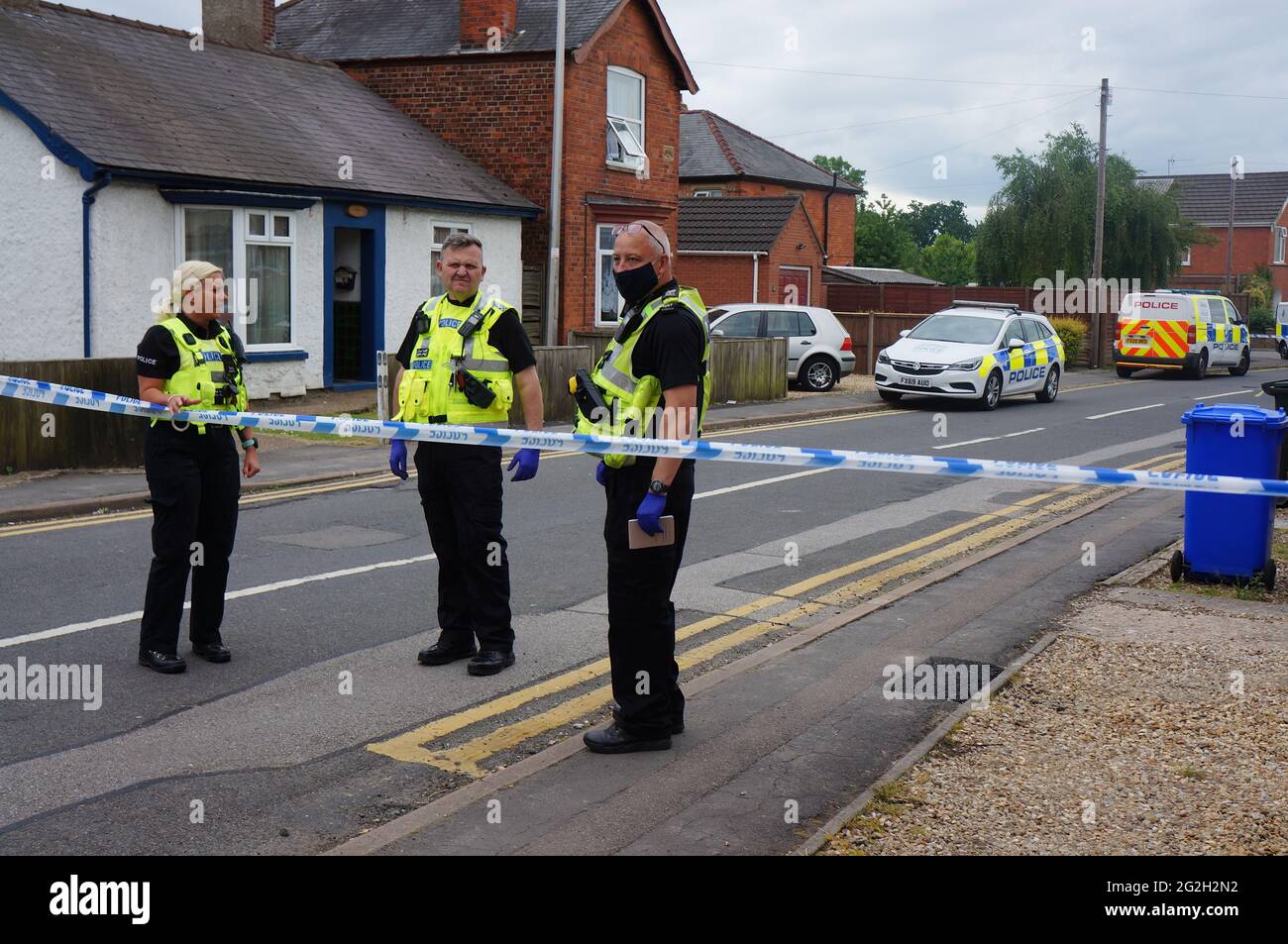 Police officers and vehicles on Wyberton West Road after a bomb scare in a house which resulted in the nearby homes being evacuated Stock Photo