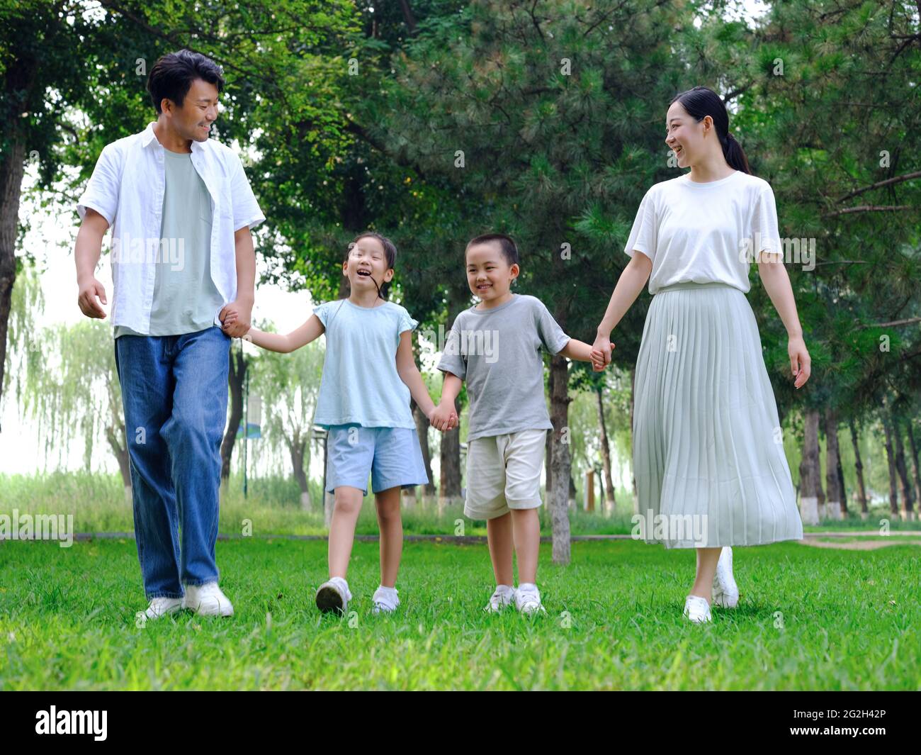 Happy family of four playing in the park high quality photo Stock Photo ...