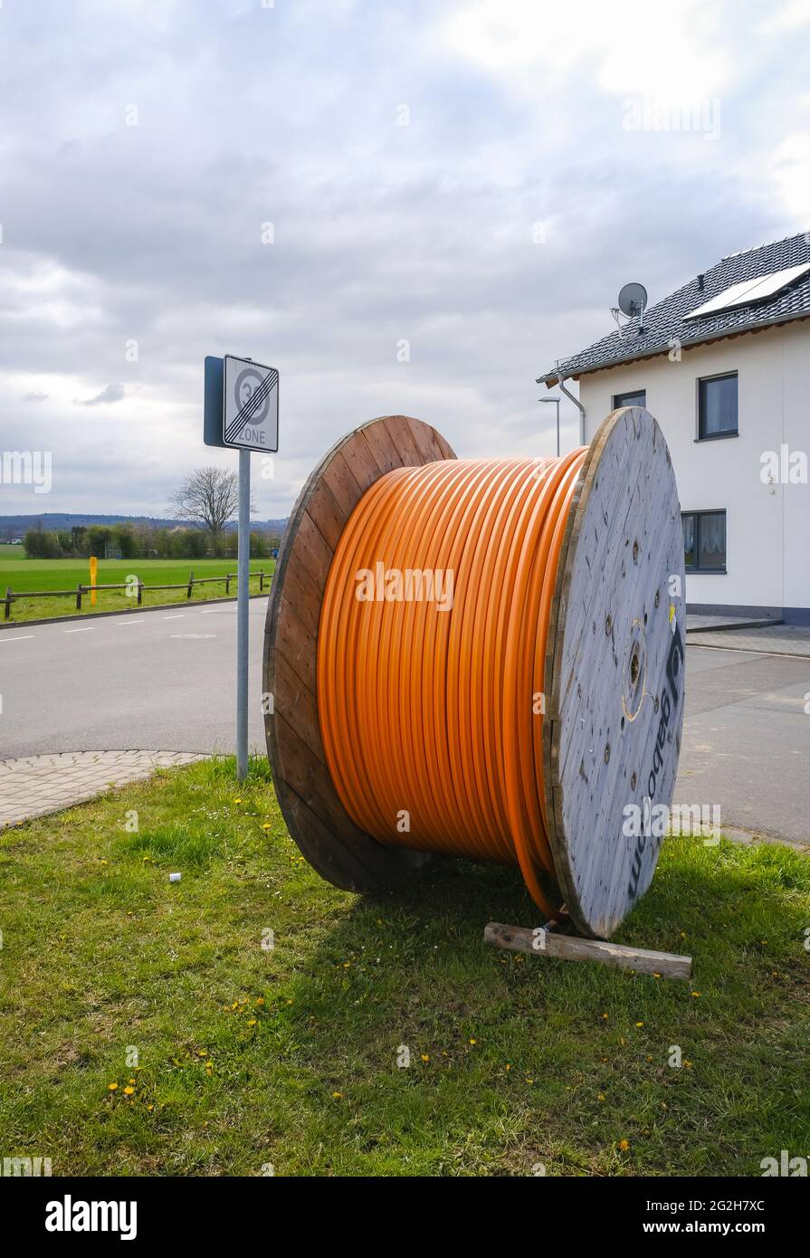 Rheinbach, North Rhine-Westphalia, Germany - Internet broadband expansion, construction site burial of fiber optic cable, cable drum with fiber optic cable, new construction of fiber optic routes on behalf of Telekom, fast Internet, DSL cable connection for households. Stock Photo