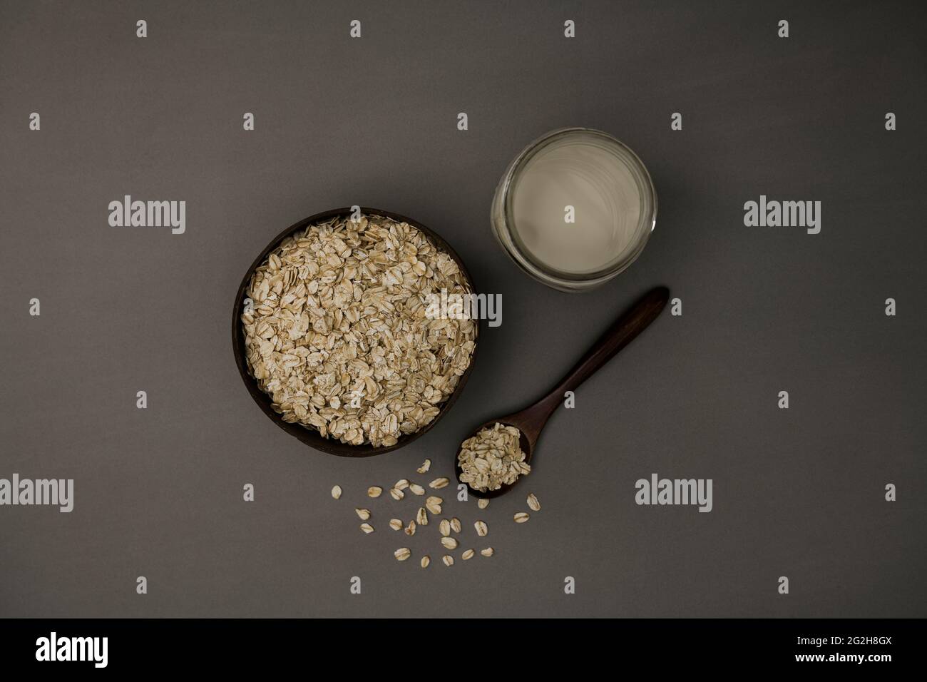 Oat milk, bowl, oatmeal, spoon, top view Stock Photo