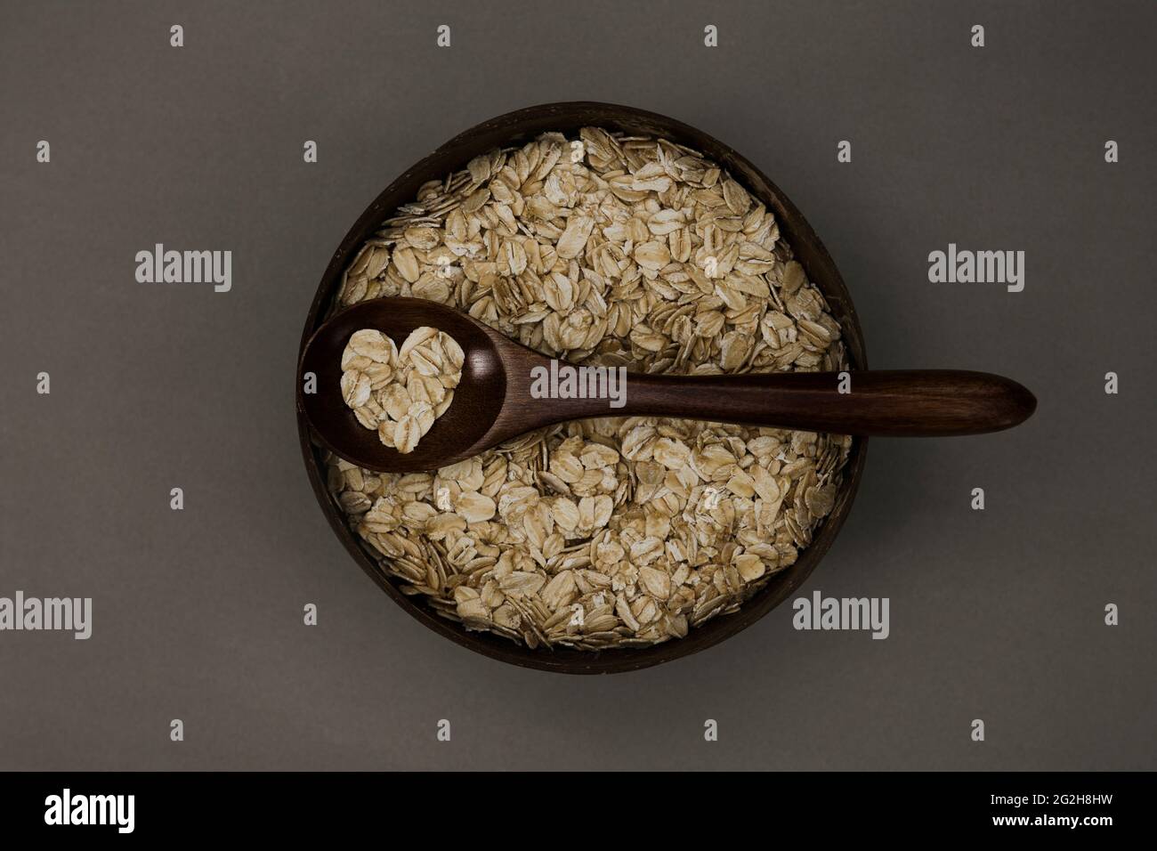 Bowl, oatmeal, spoon, heart, top view Stock Photo