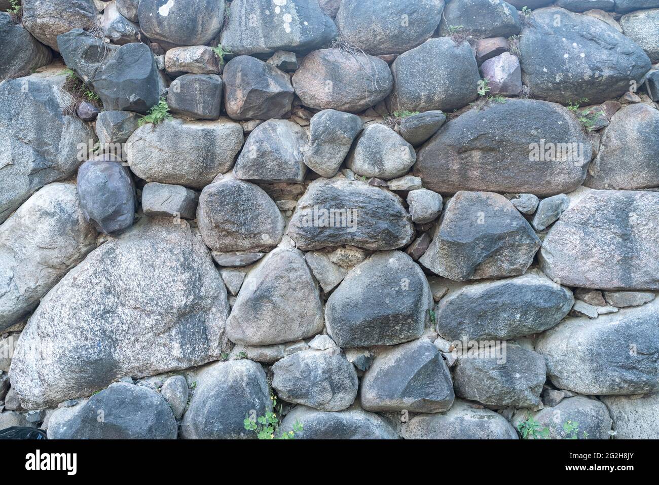 Texture of a stone wall. Old castle stone wall texture background. Stone wall as a background or texture. Part of a stone wall, for background or texture. High quality photo Stock Photo