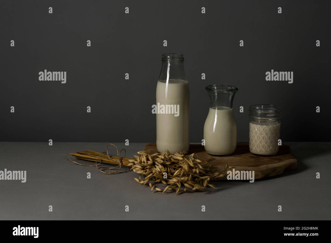 Oat milk, platter, ear of wheat, milk bottle, carafe, mason jar Stock Photo