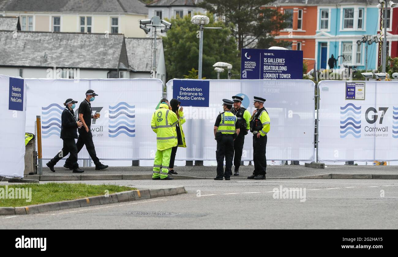 Cornwall, Britain. 11th June, 2021. Police officers and security personnel work outside the G7 media center in Falmouth, Cornwall, Britain, on June 11, 2021. The first in-person G7 summit kicked off on Friday in Britain's southwestern resort of Carbis Bay, Cornwall, in almost two years. Credit: Han Yan/Xinhua/Alamy Live News Stock Photo