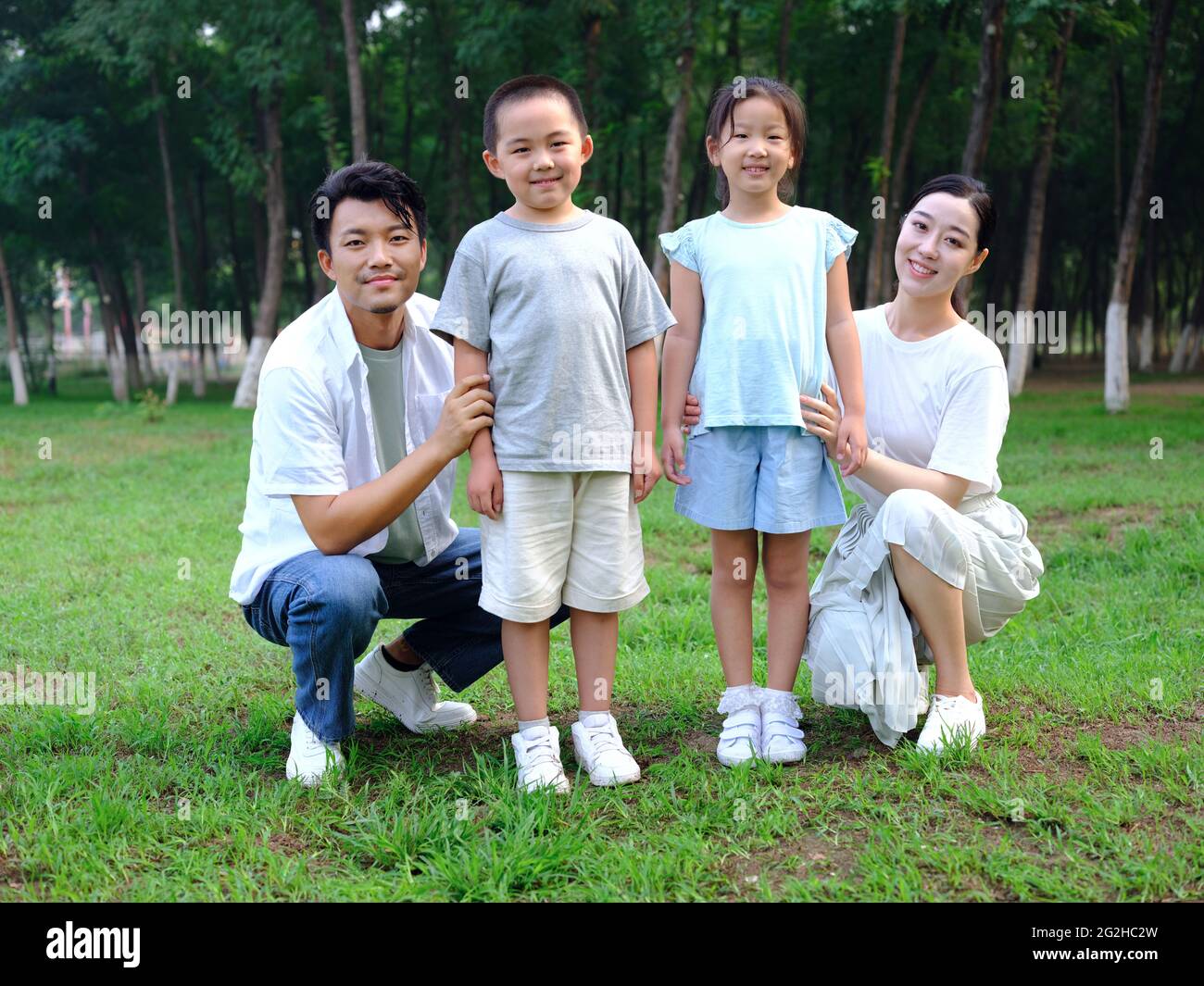 Happy family of four playing in the park high quality photo Stock Photo ...