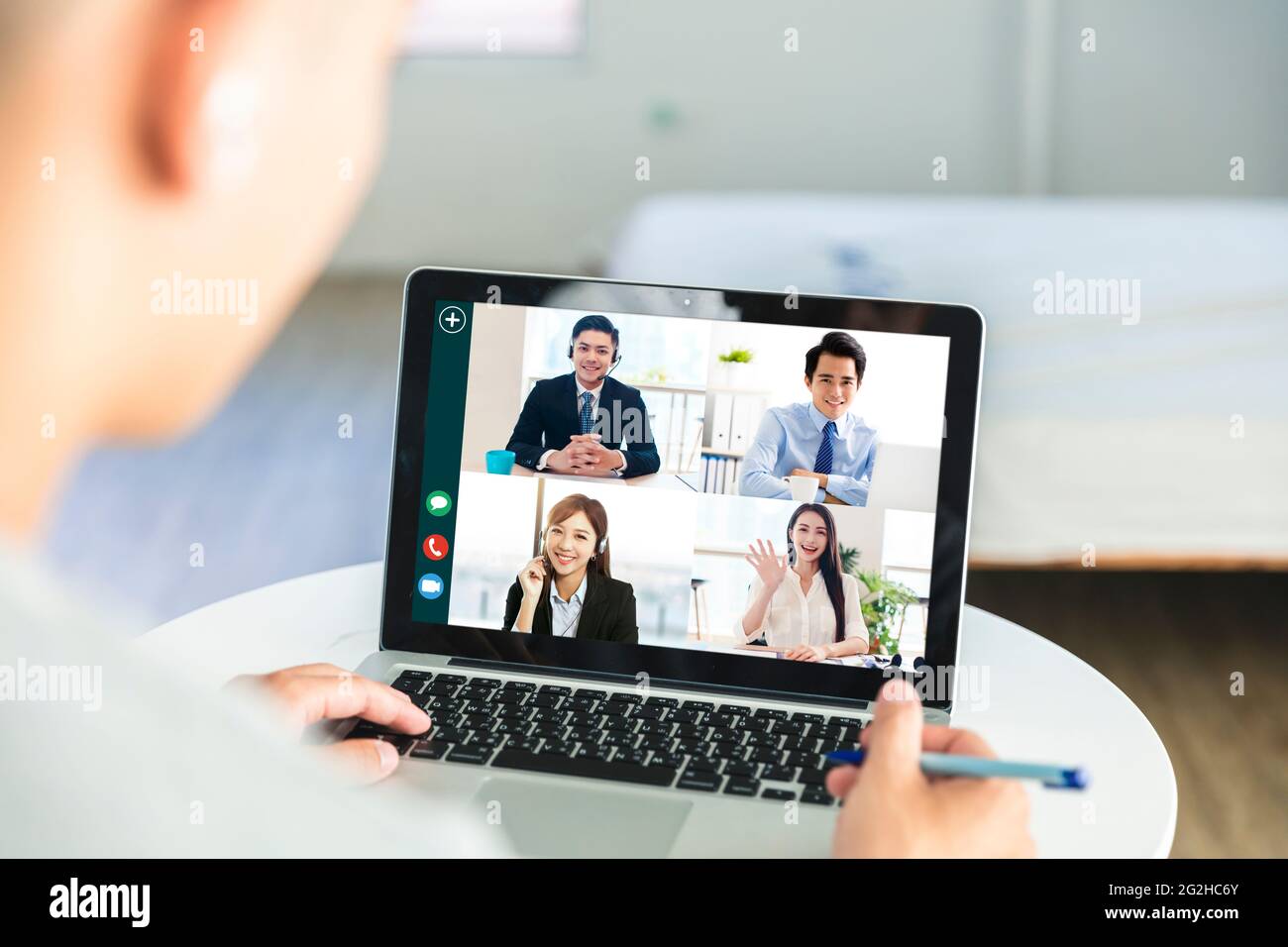 Business people use laptops for web meetings at home, discuss work and schedules with colleagues through webcams Stock Photo