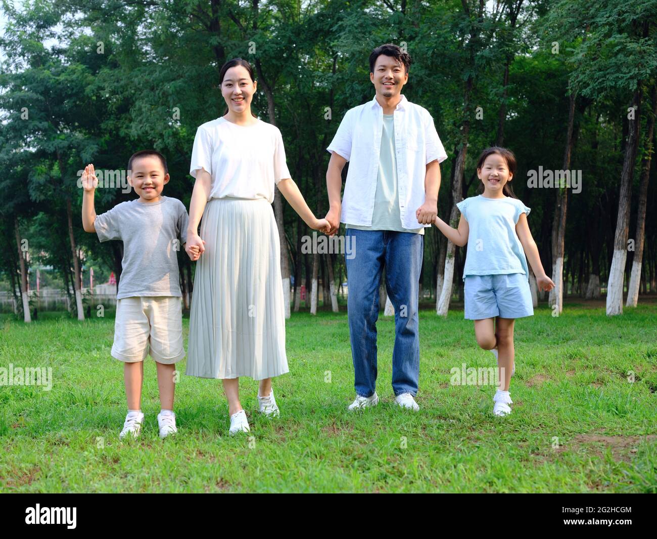 Happy family of four playing in the park high quality photo Stock Photo ...