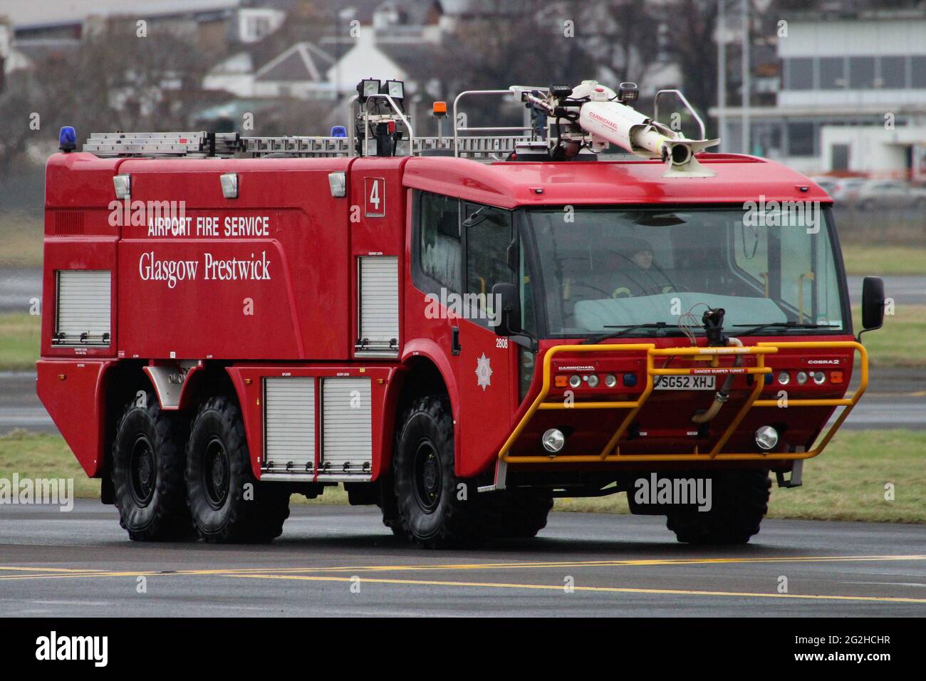 SG52 XHJ (2808), a Carmichael Cobra 2 operated by the Glasgow Prestwick Airport Fire Service, motoring along the taxi-way at its home base. Stock Photo