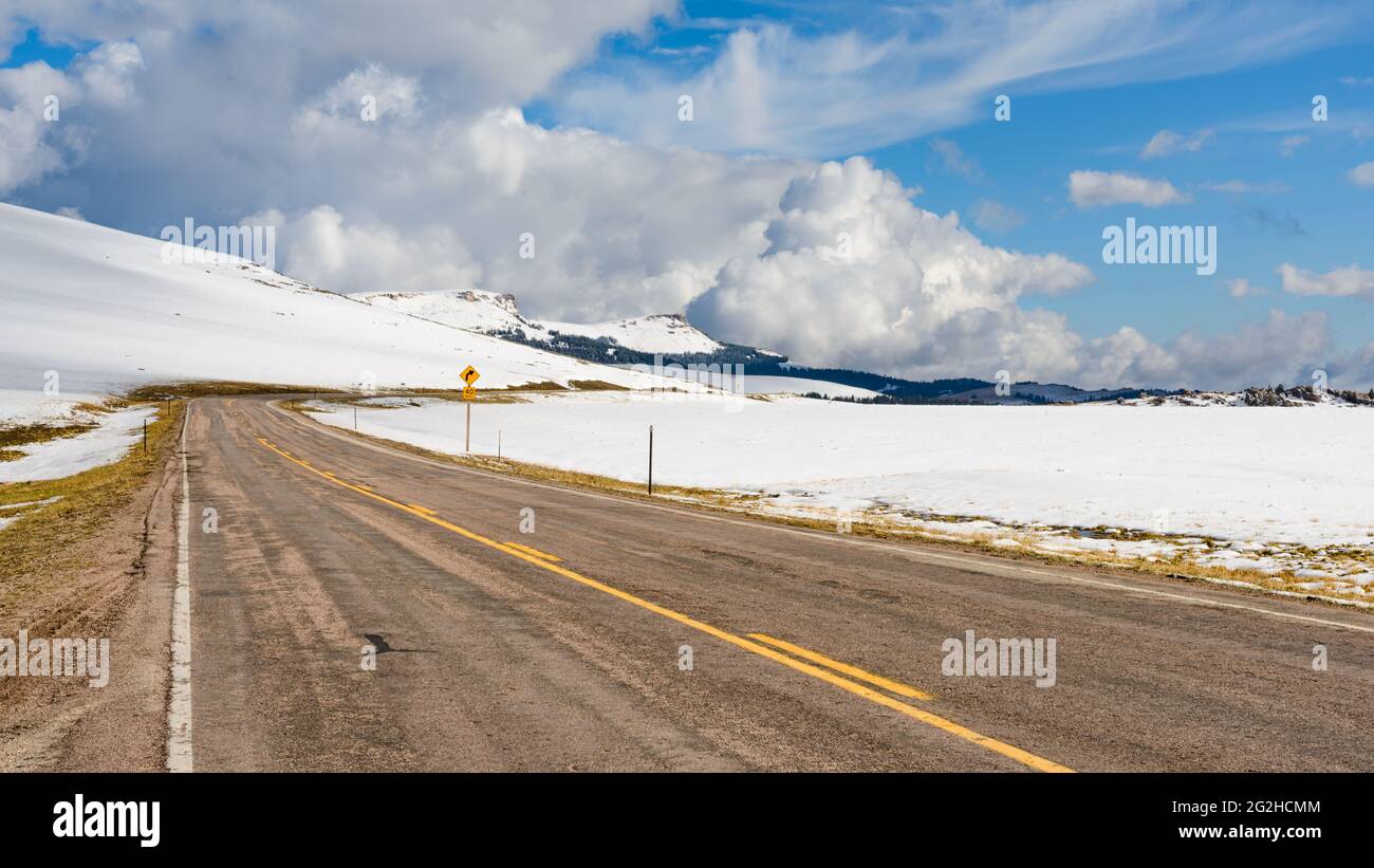 Medicine Wheel Passage Scenic Byway crossing the Bighorn Mountains in Wyoming.  The first snow of winter covers the nearby land Stock Photo