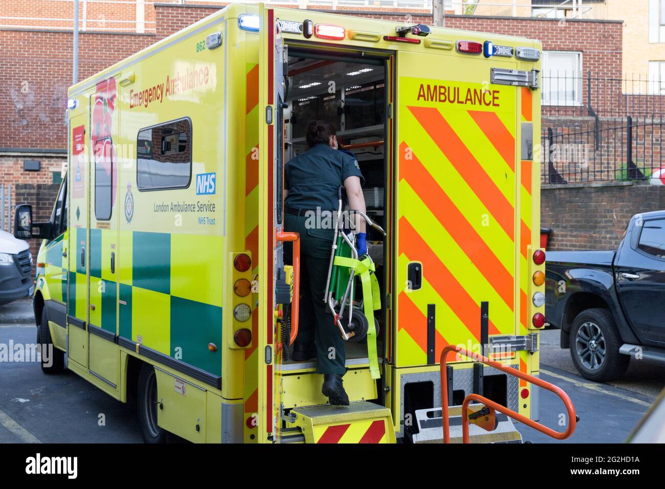 Medical staff carries strecher through rear door of London Ambulance, London, England UK Stock Photo