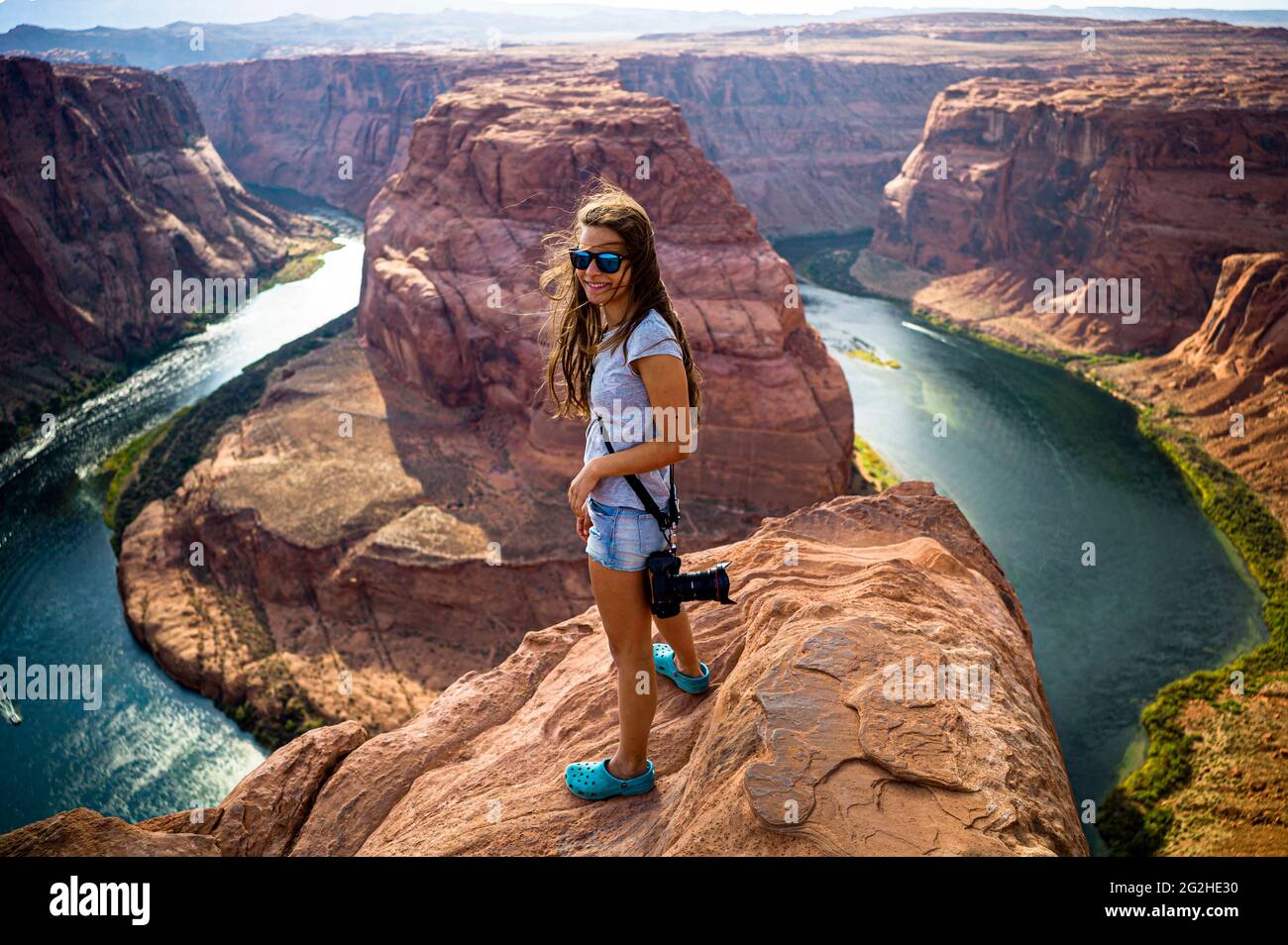 Girl at the cliff on a late afternoon at Horseshoe Bend, Colorado River, Arizona, USA. Stock Photo