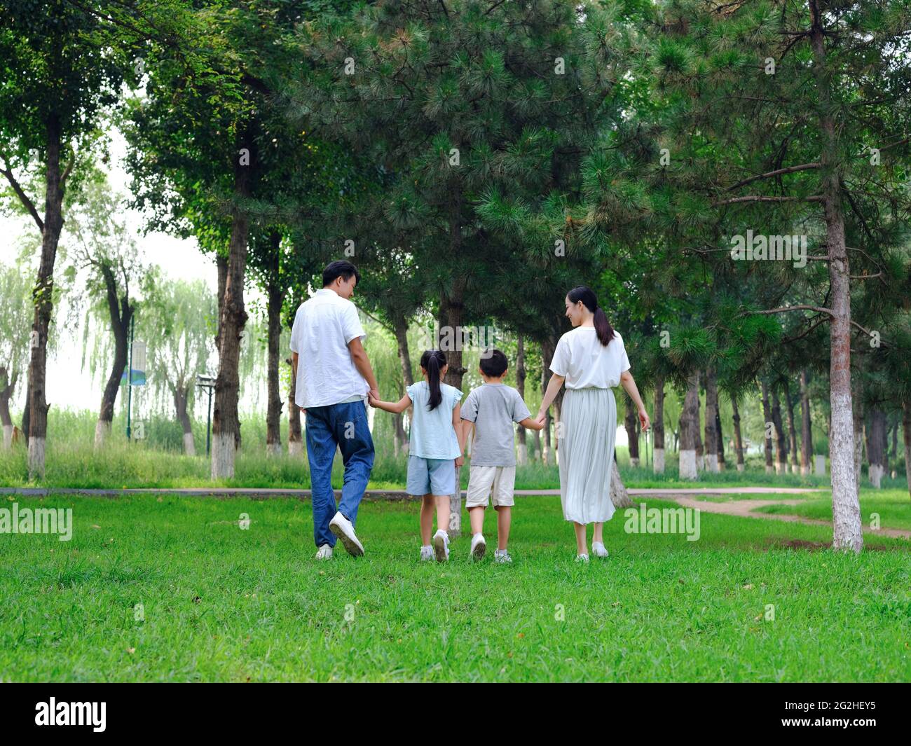 Happy family of four playing in the park high quality photo Stock Photo ...