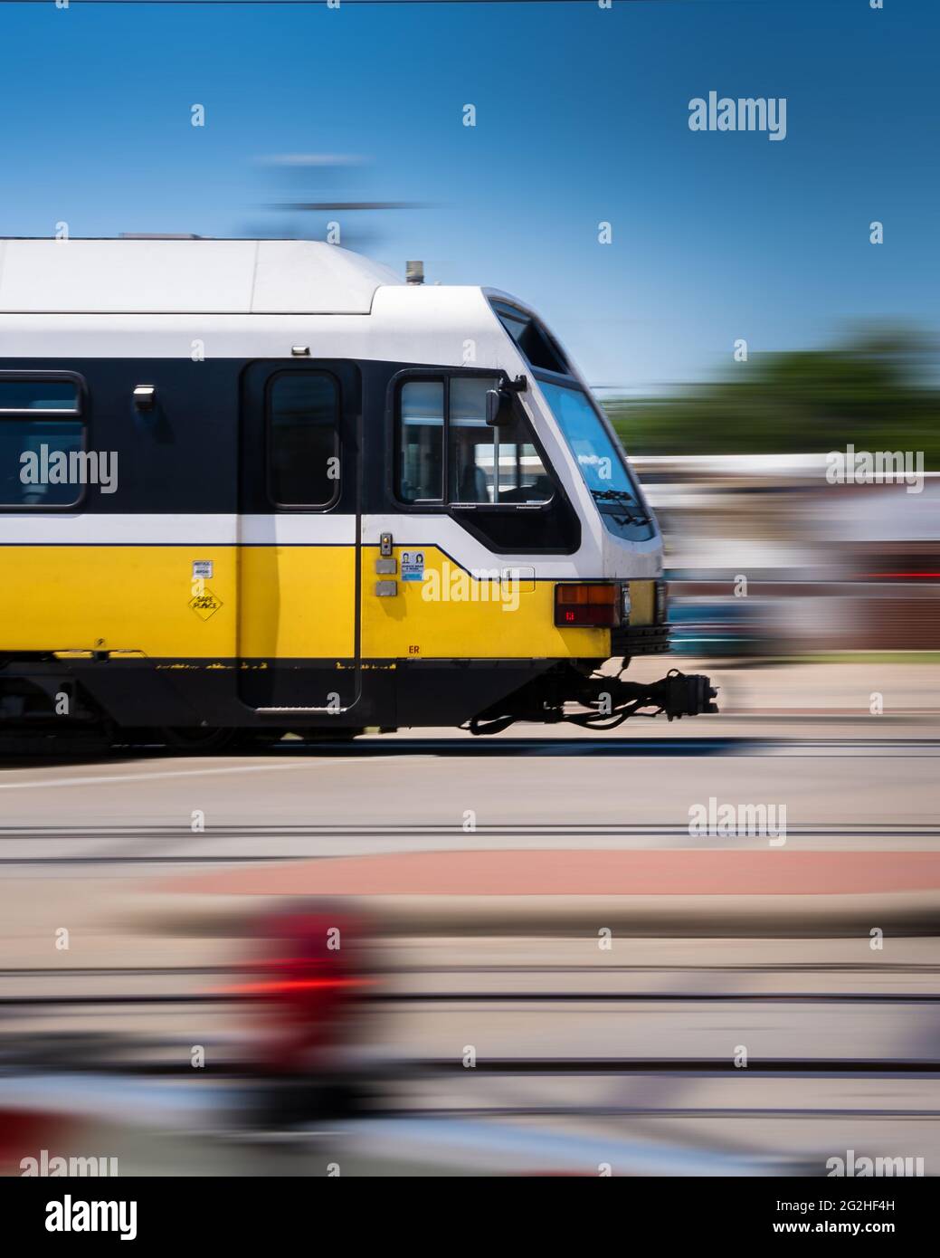 Subway Train in Action Moving Thru Suburban Area, Moving Railway Train with Motion Blur, Modern Public Transport at High Speed Stock Photo