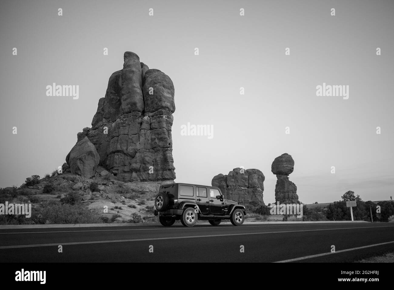 Wrangler Jeep at the parking spot at the Balanced Rock - a massive rock resting on a narrow pillar in Arches National Park, near Moab in Utah, USA Stock Photo