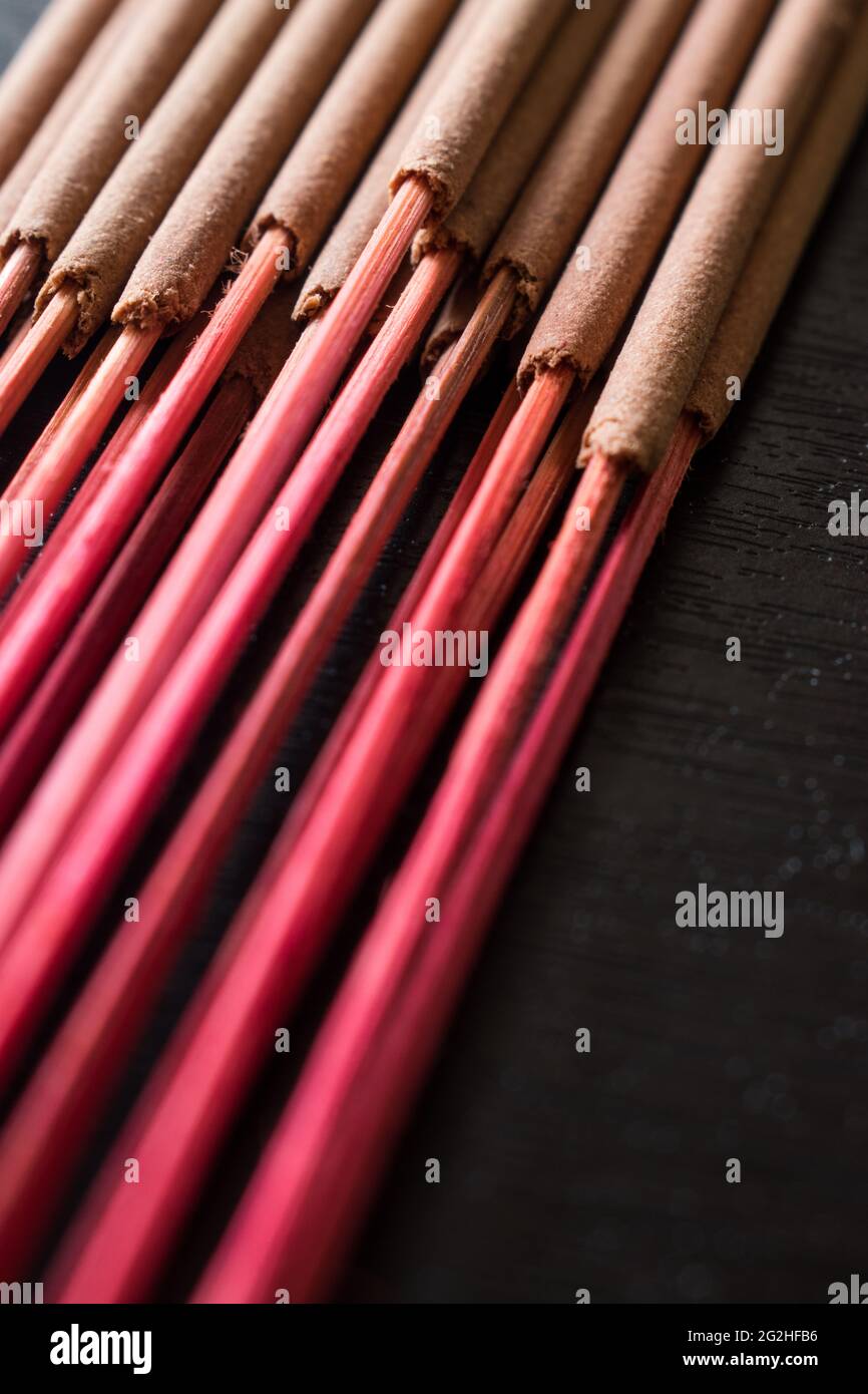 Some red incense branches on a black wooden table in a spa Stock Photo