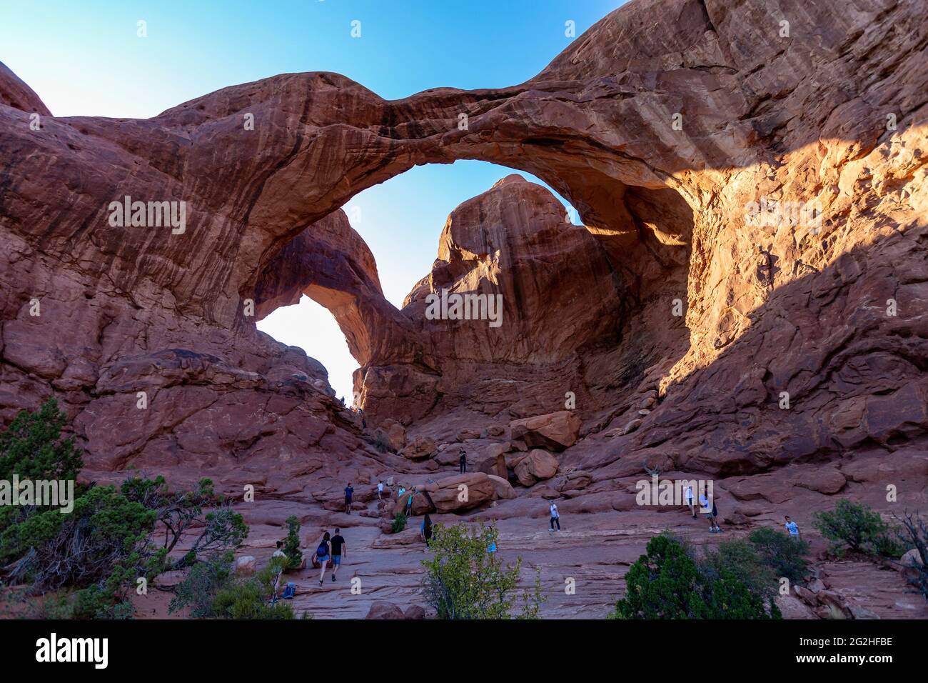 The famous Double Arch - a sandstone formation & popular photo spot with two big arches springing from the same side foundation - noted for front & back spans in Arches National Park, near Moab in Utah, USA Stock Photo