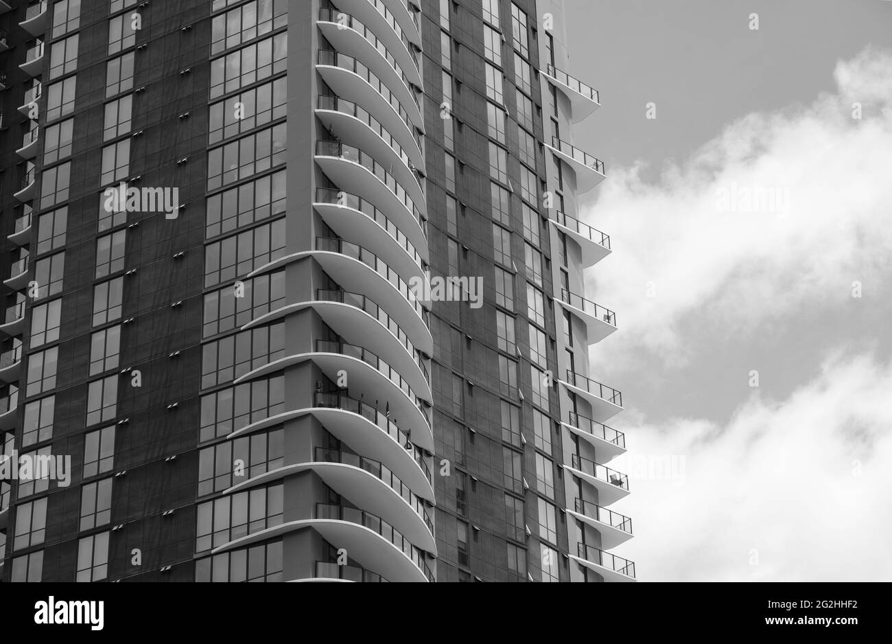 Stylish balconies on residential high rise building in black and white ...