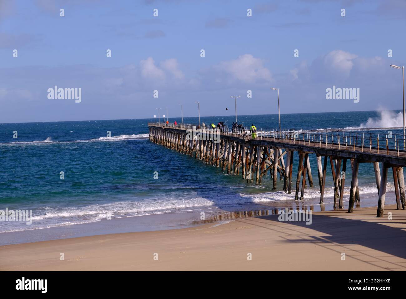 People fishing from the jetty at Port Noarlunga in South Australia