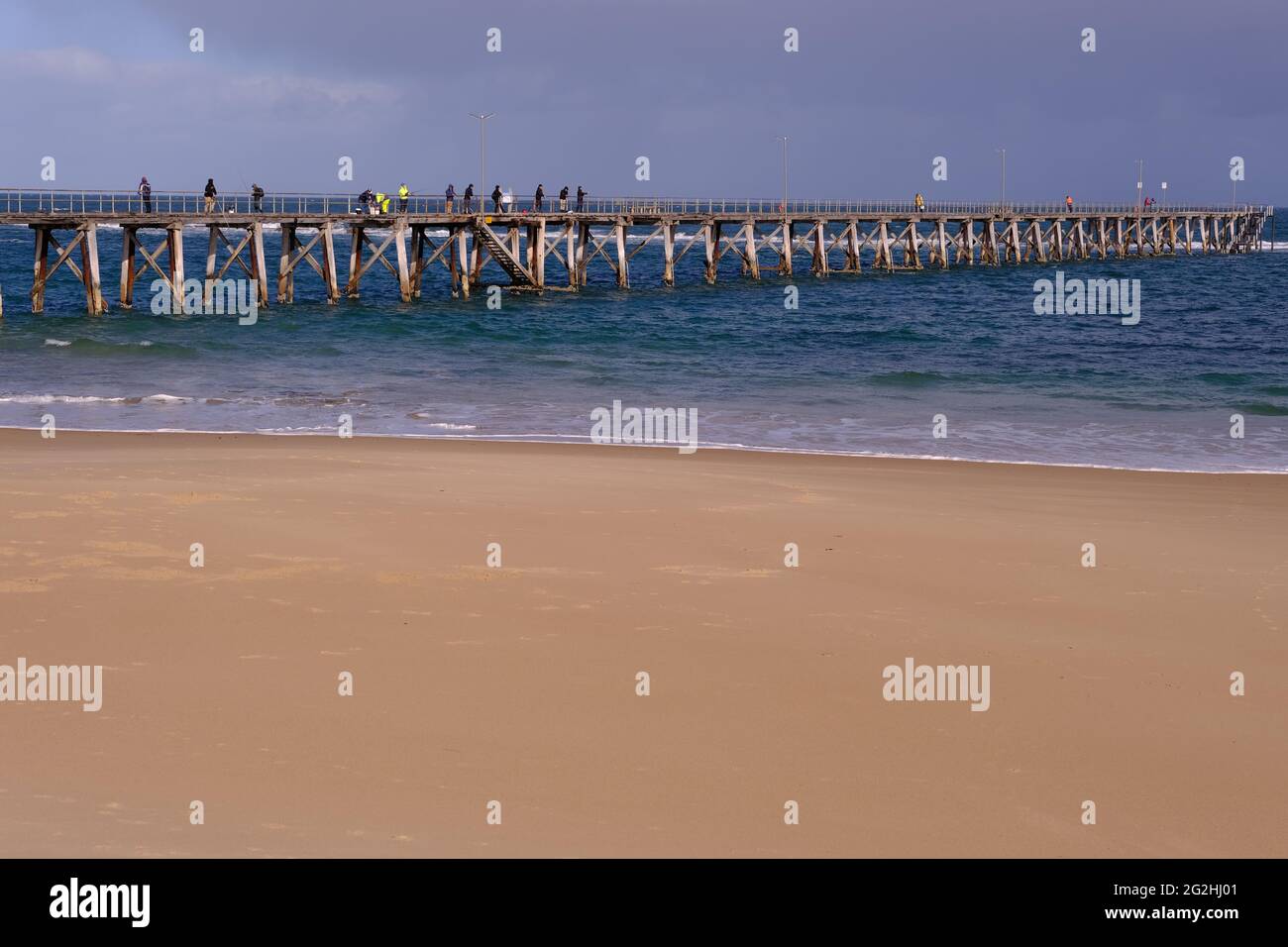 People fishing from the jetty at Port Noarlunga in South Australia