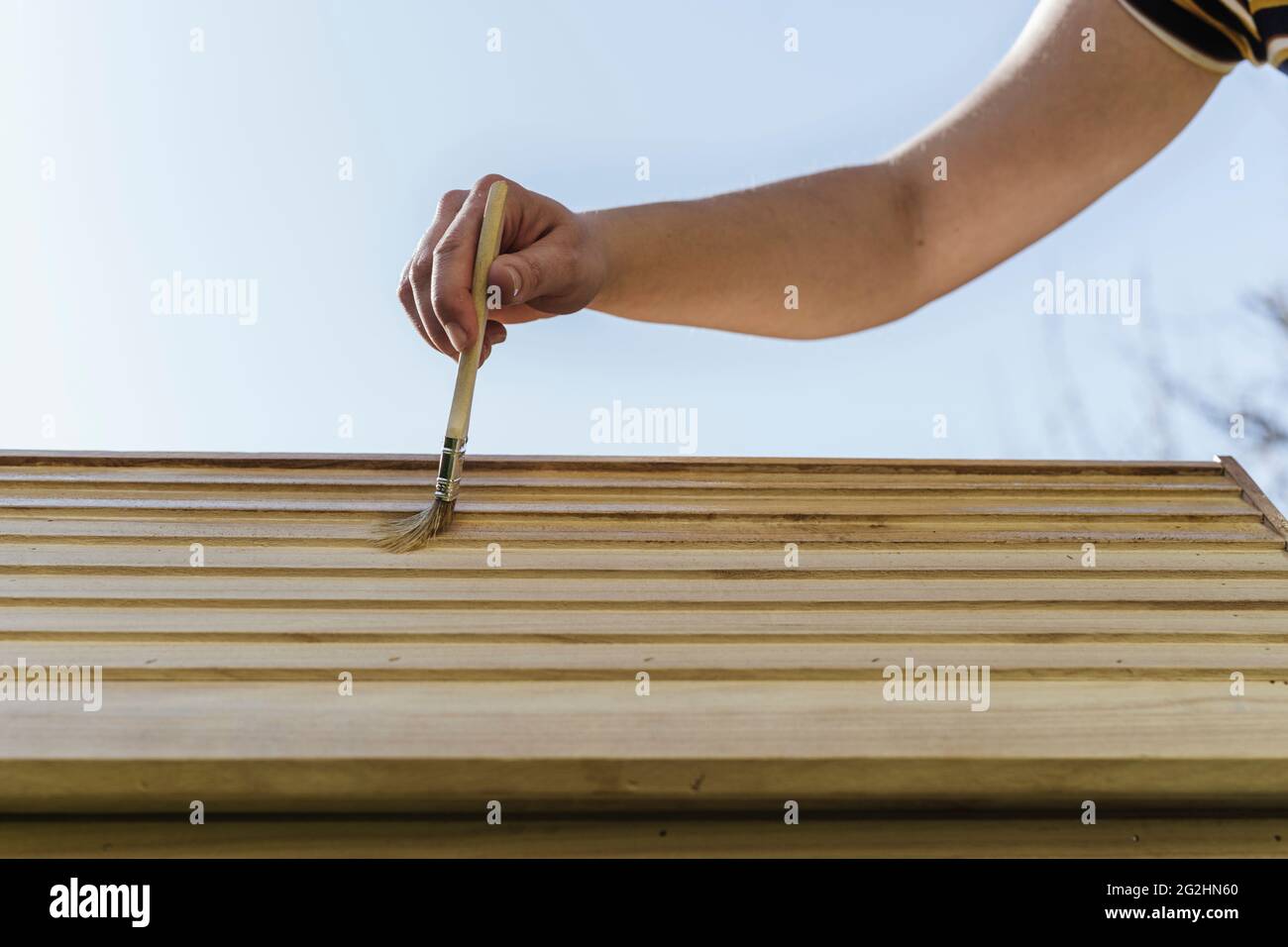 Organic beekeeper paints beehives with linseed oil Stock Photo Alamy