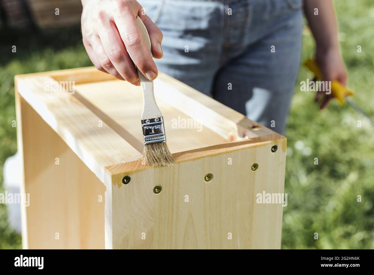 Organic beekeeper paints beehives with linseed oil Stock Photo Alamy