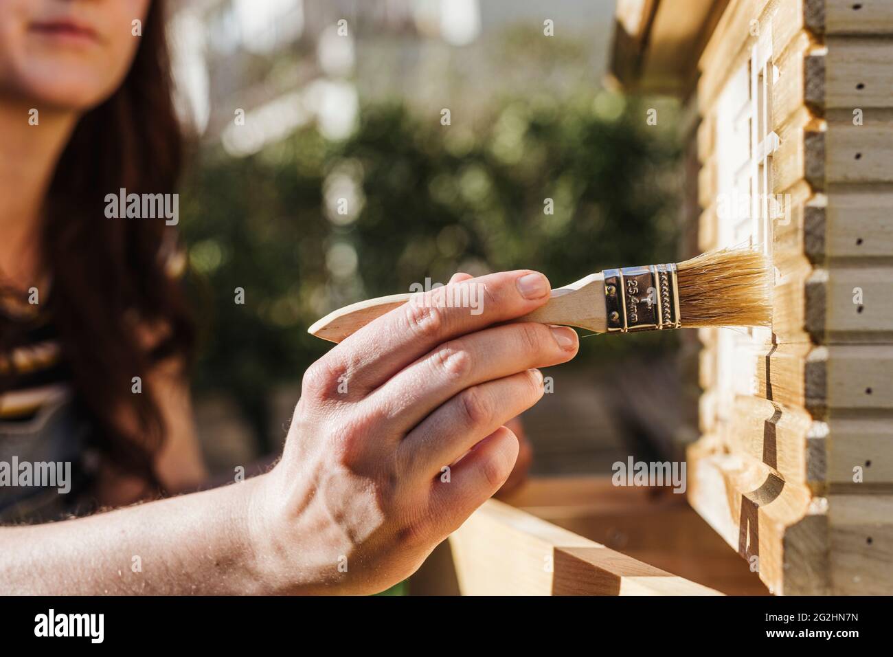 Organic beekeeper paints beehives with linseed oil Stock Photo Alamy