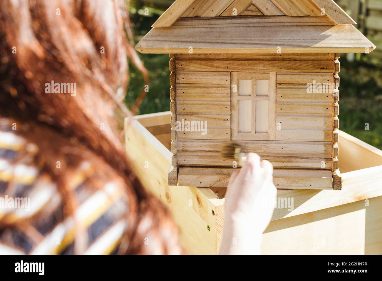 Organic beekeeper paints beehives with linseed oil Stock Photo Alamy