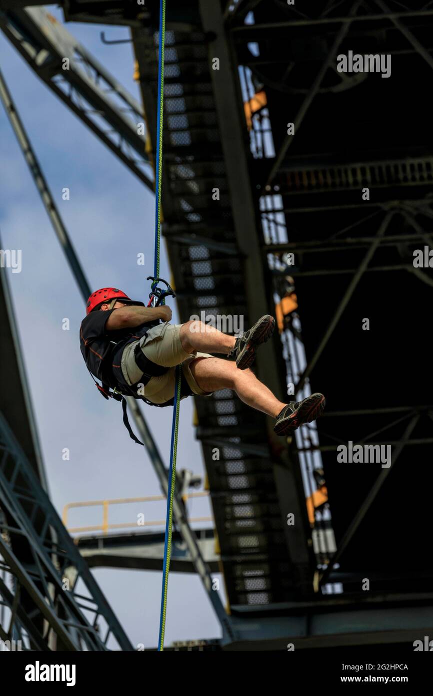 Test of courage at lofty heights, abseiling from 60 meters from the conveyor bridge F60 Stock Photo