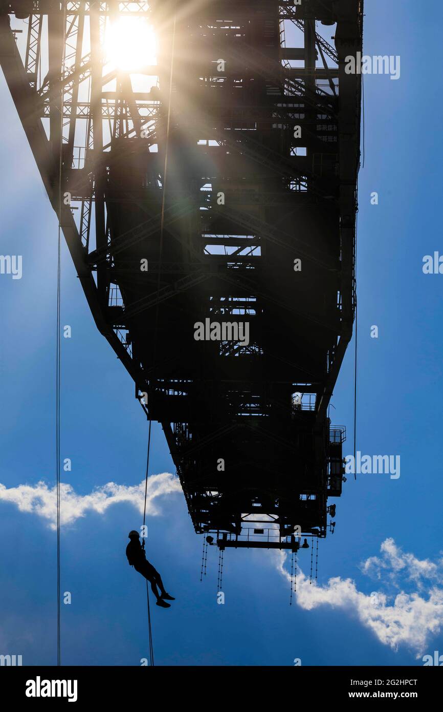 Test of courage at lofty heights, abseiling from 60 meters from the conveyor bridge F60 Stock Photo