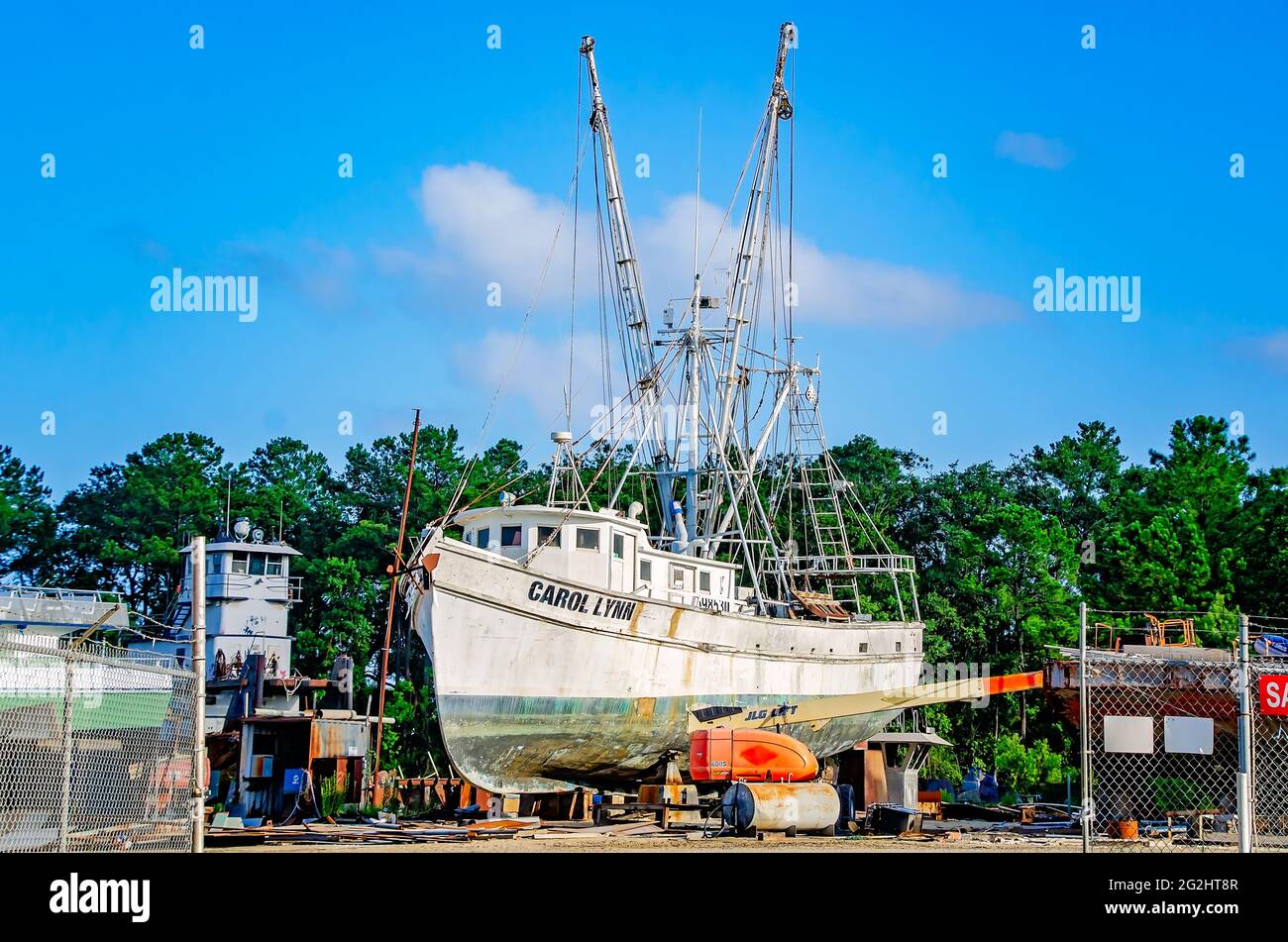 An old wooden shrimp boat sits in dry dock for repair at a local shipyard, June 9, 2021, in Bayou La Batre, Alabama. Stock Photo