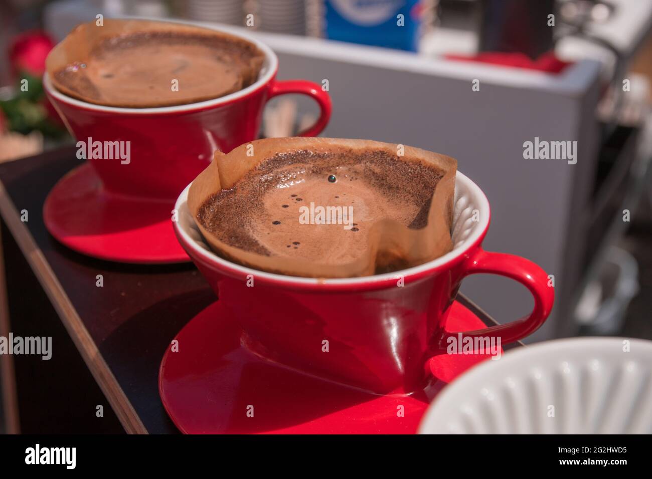 Freshly brewed, hot coffee in the coffee filter. Stock Photo