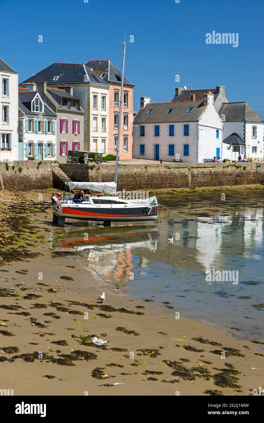 Île de Sein, colorful houses and sailing boat in the harbor, France, Brittany, Finistère department Stock Photo