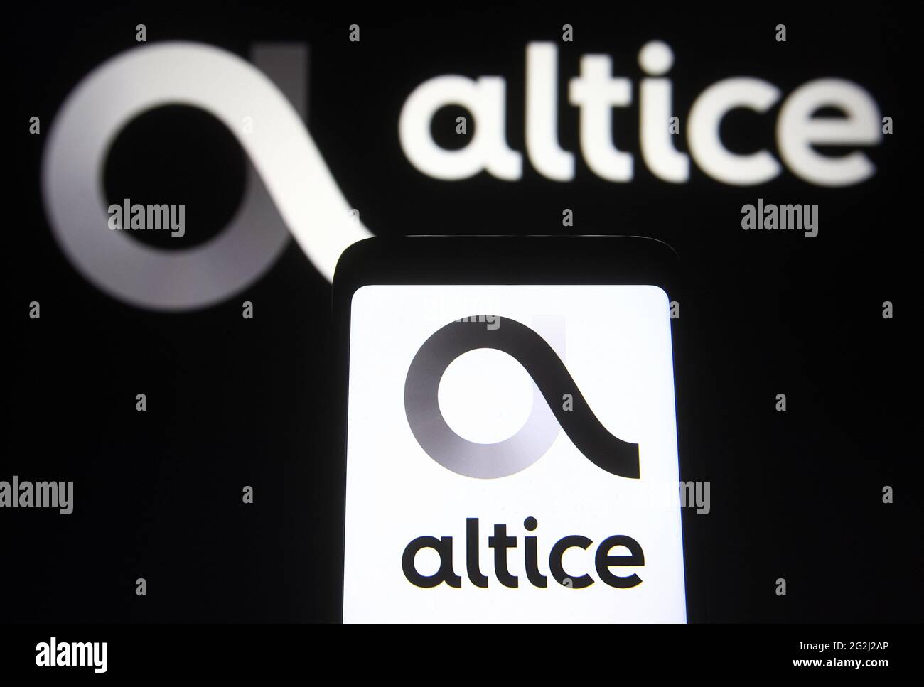 Ukraine. 11th June, 2021. In this photo illustration an Altice USA logo logo is seen on a smartphone and a pc screen. (Photo by Pavlo Gonchar/SOPA Images/Sipa USA) Credit: Sipa USA/Alamy Live News Stock Photo