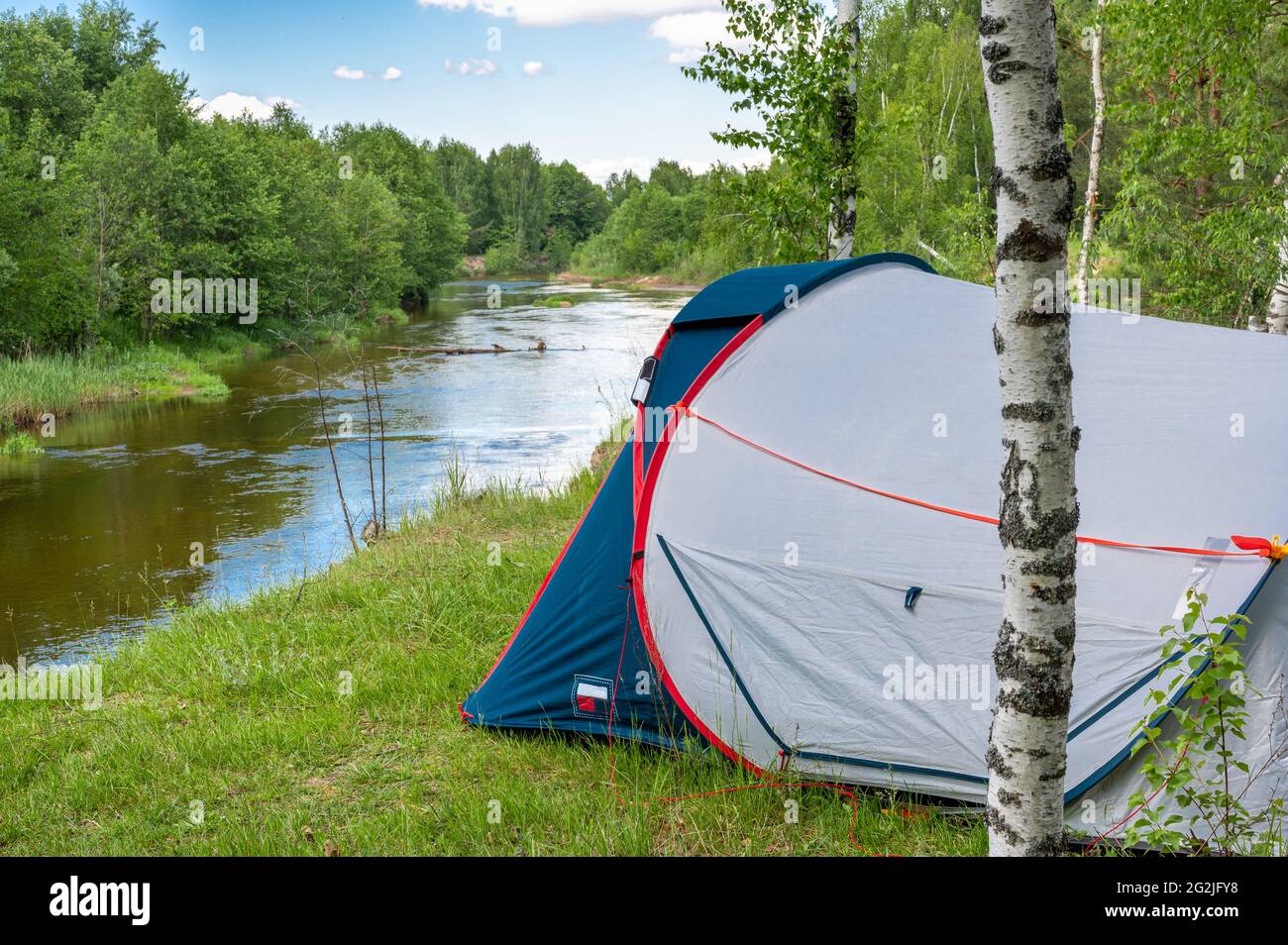 Camping tent in a forest by the river. Tourist tent in forest. tourist background. Nature tourism, Lifestyle and camping holiday concept Stock Photo