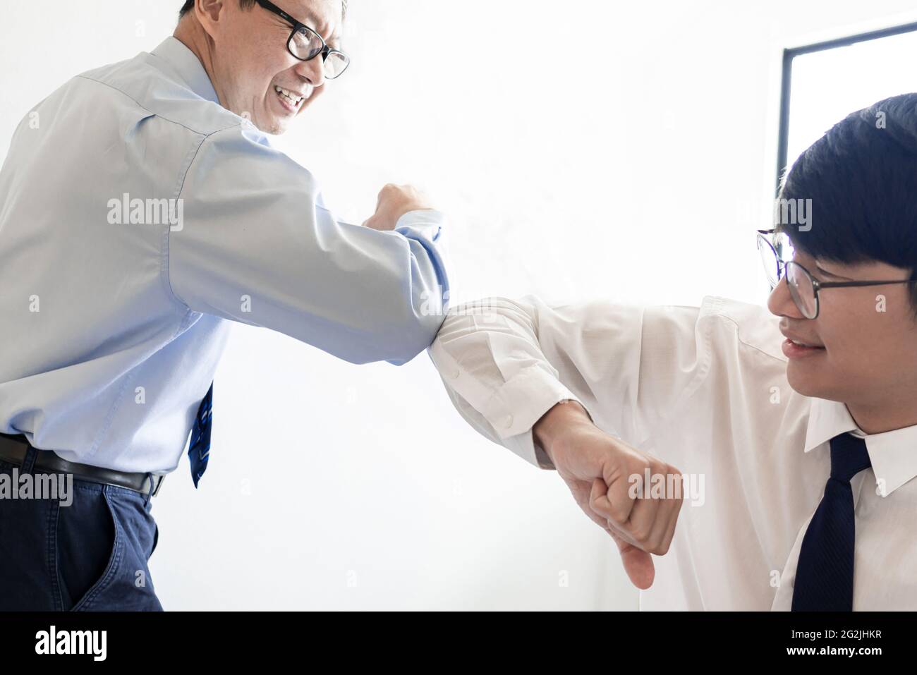 two entrepreneurs touching elbows together for the new partnership