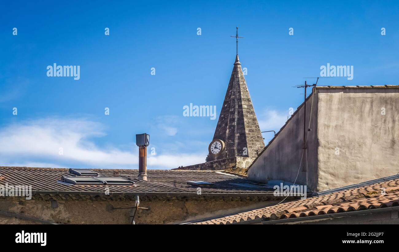 View of the tower of the Saint Paul church in Puisserguier. It was built in the XIV century and restored in the XIX. Stock Photo