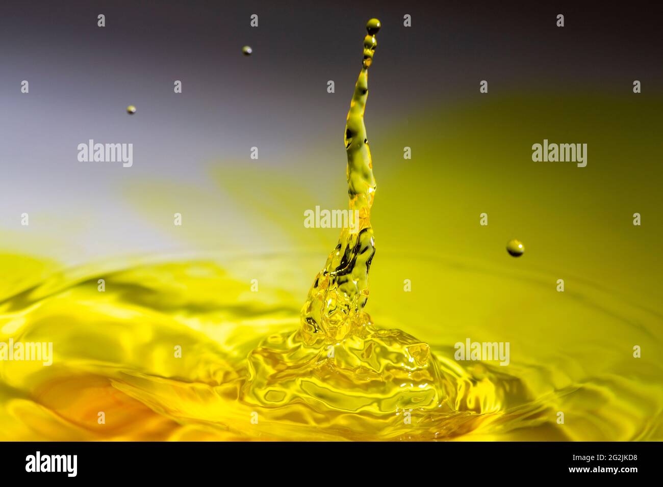 Clear water drop on a yellow tinted water Stock Photo Alamy